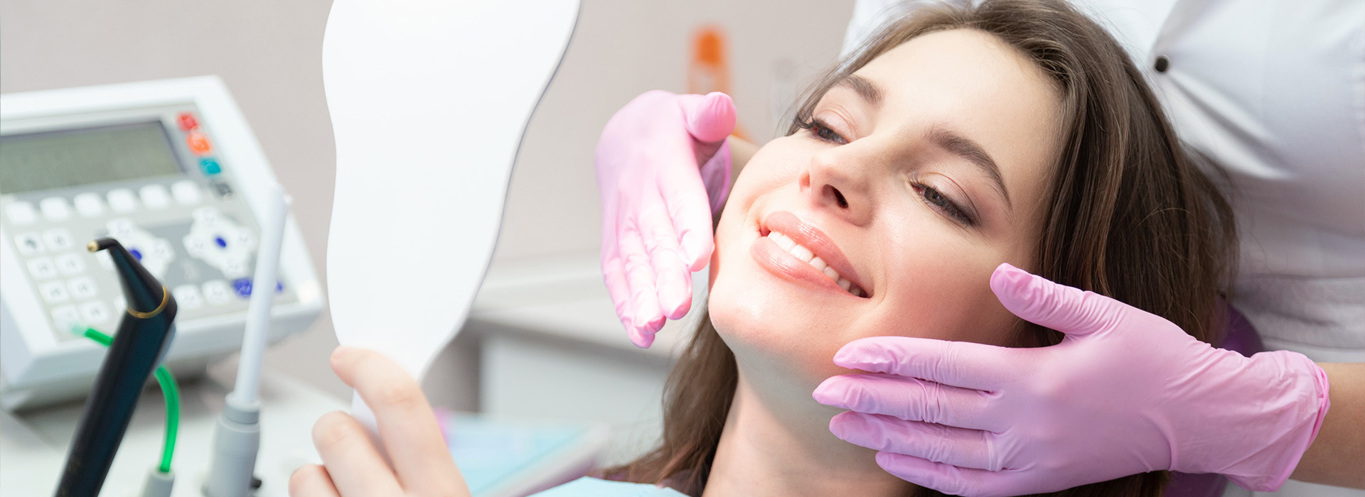 A woman receiving dental care while sitting in a dentist s chair.